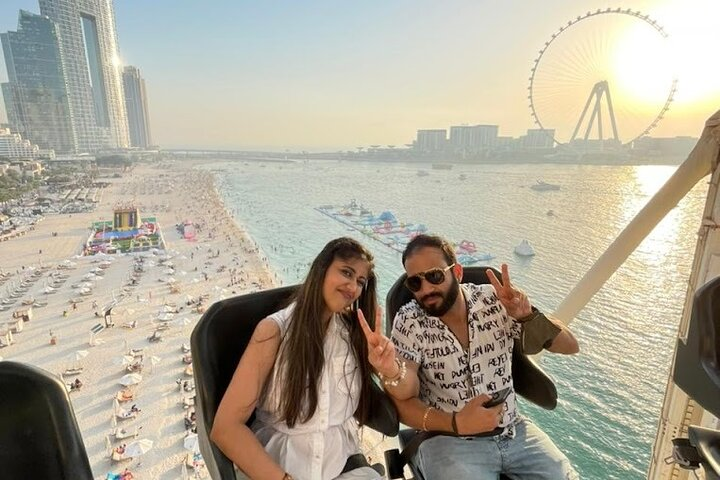 Experience dining high above iconic landmarks while enjoying stunning panoramic views of Dubai’s coast capturing unforgettable moments shared with friends against a breathtaking skyline.